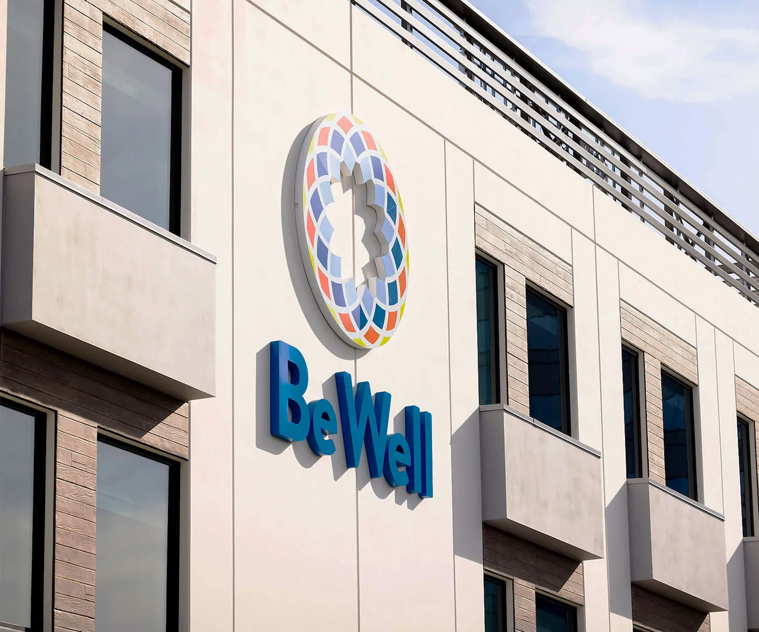 BeWell signage and circular logo on a building facade.