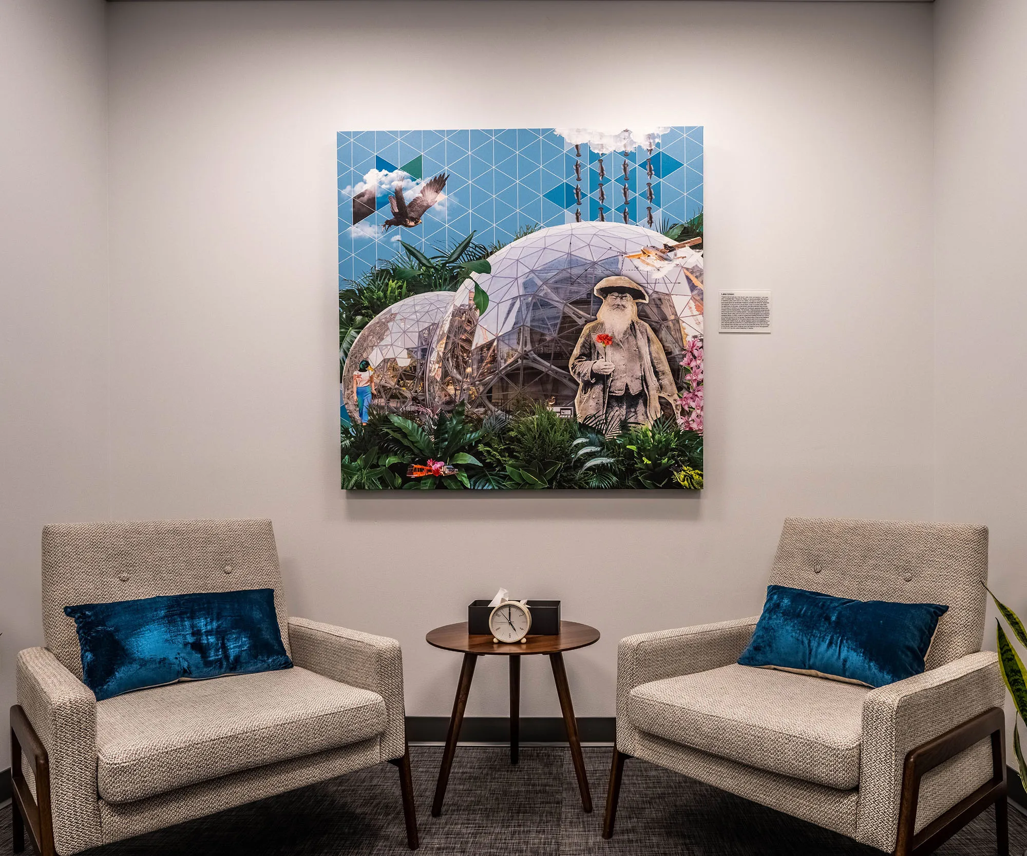 Clinic waiting area with a large landscape artwork above the chairs.