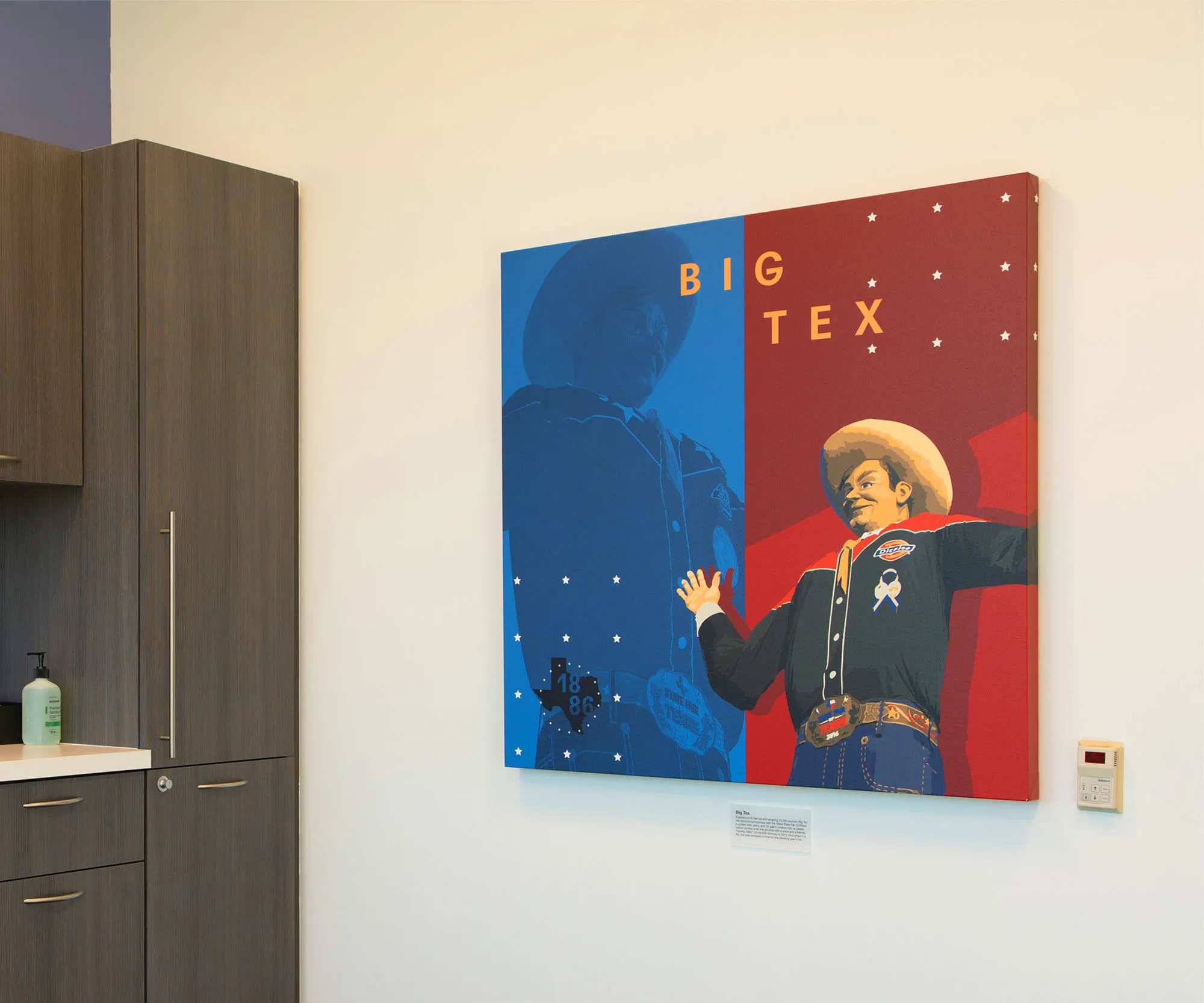 Clinic wall with a "Big Tex" cowboy artwork panel.