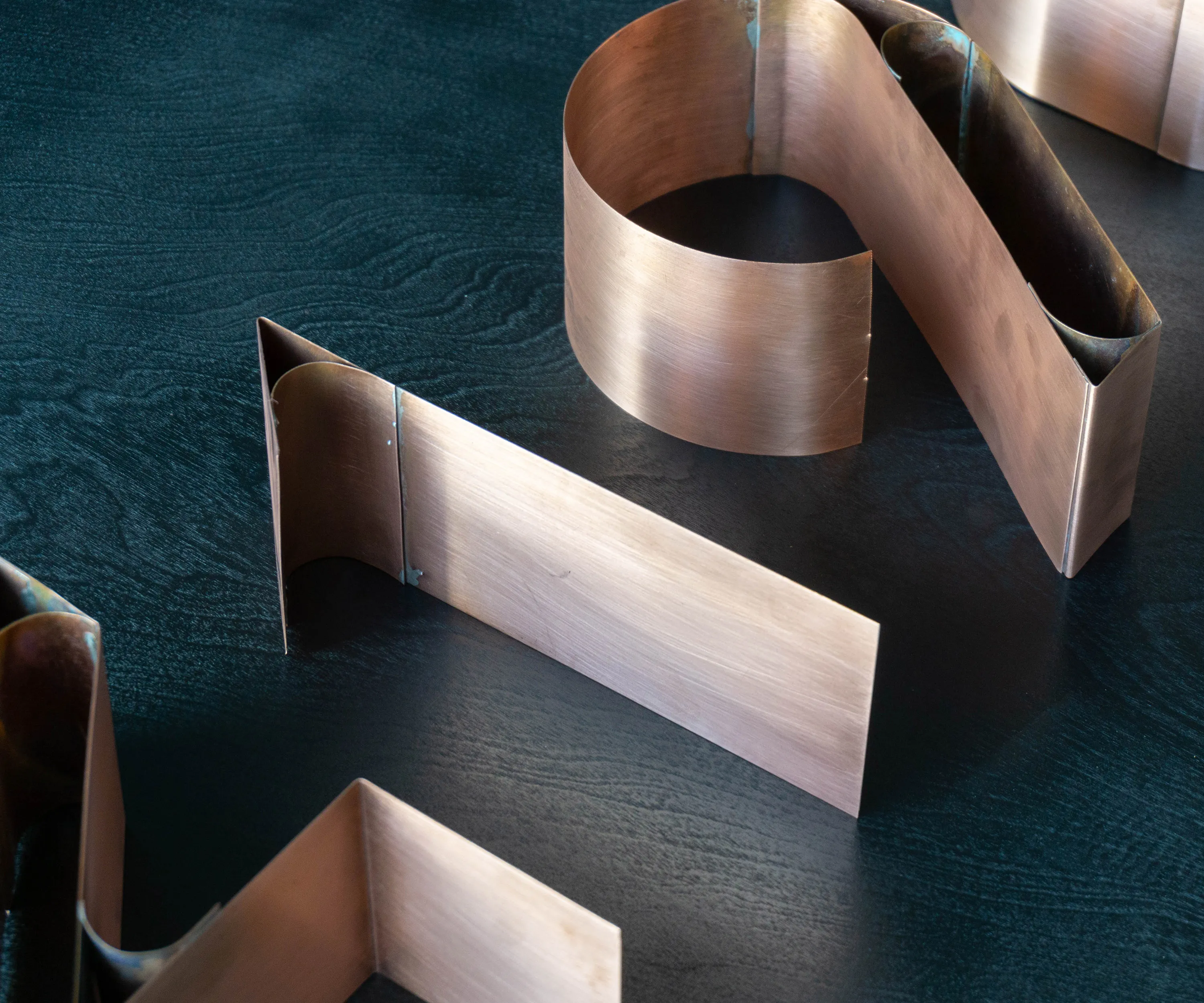 Copper numerals on a dark wooden surface.