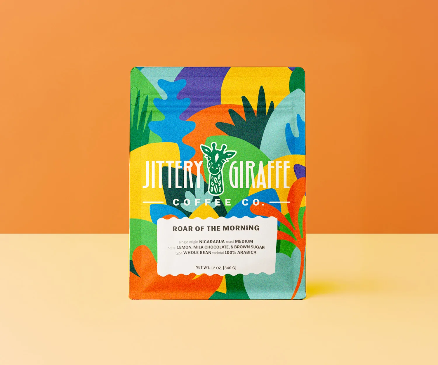 Jittery Giraffe Roar of the Morning coffee bag on orange.