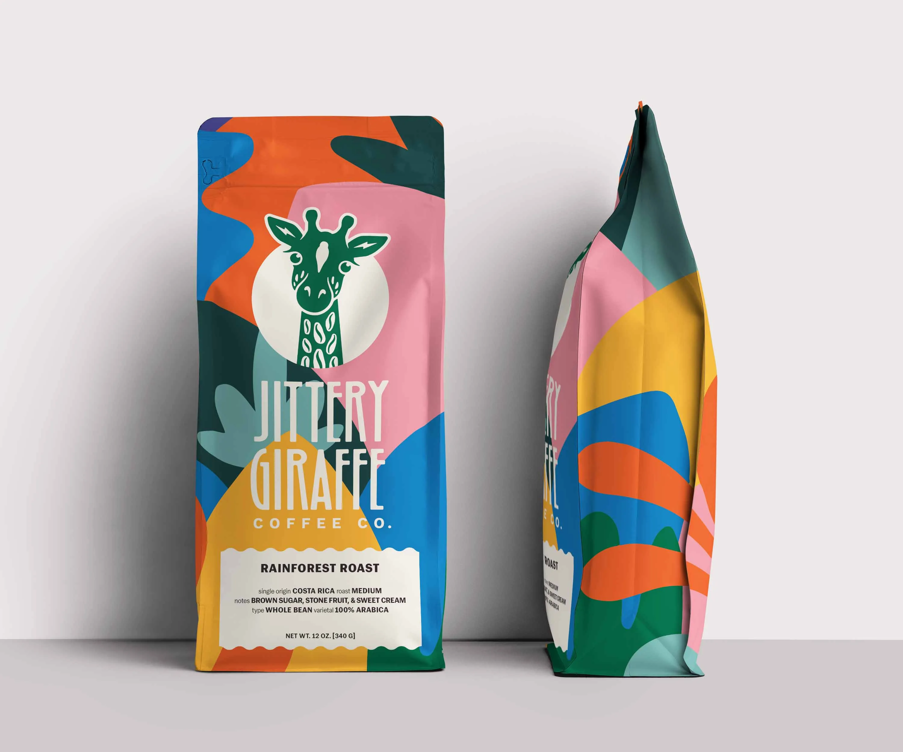 Two Jittery Giraffe coffee bags showing front and side artwork.