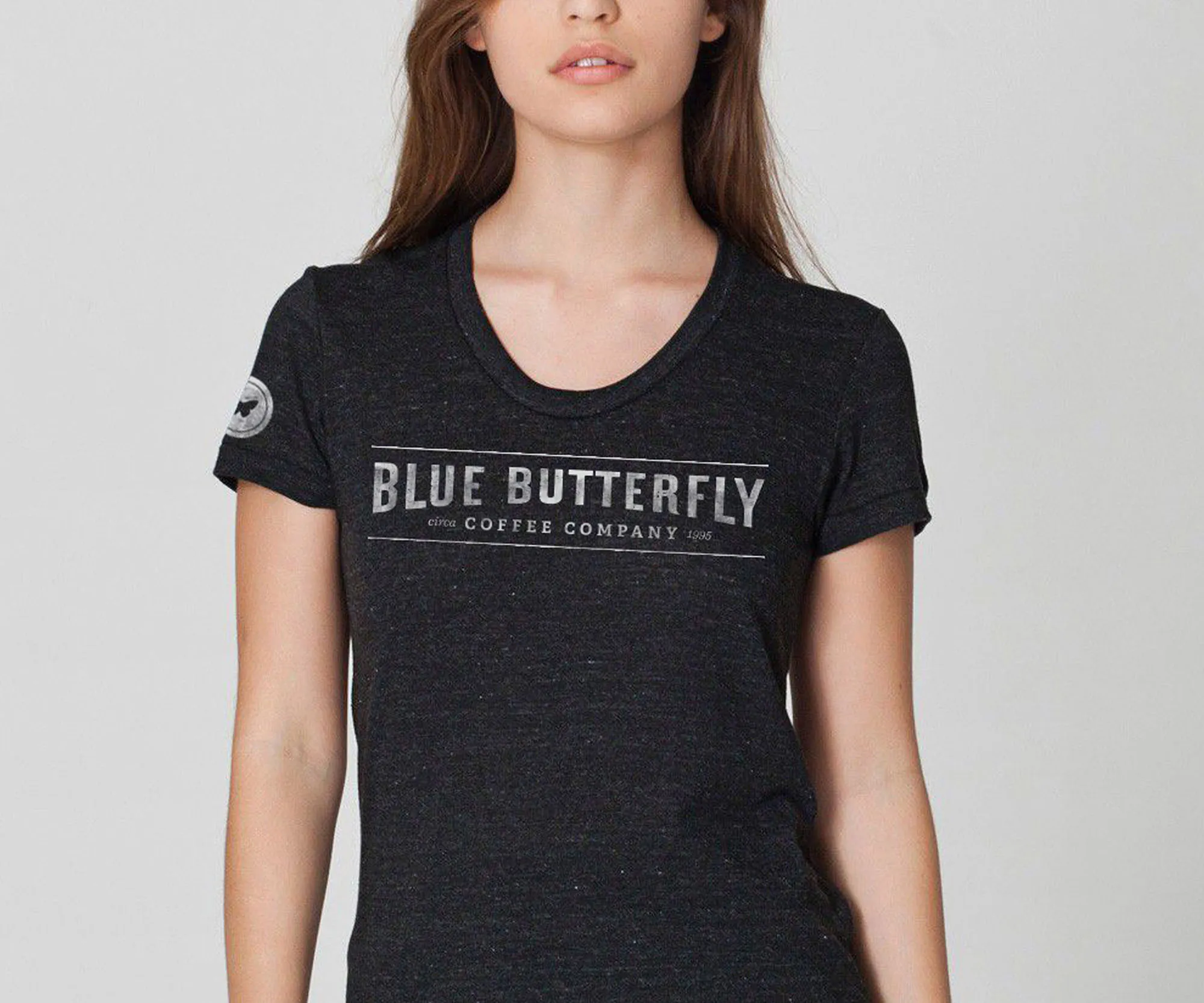Woman wearing a Blue Butterfly Coffee Company tee.