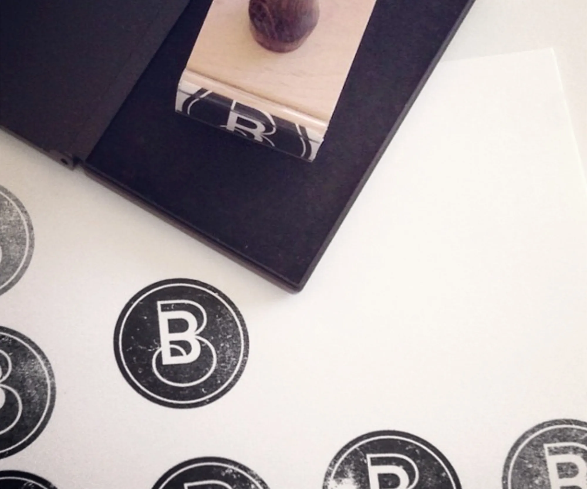 Blue Butterfly logo stickers and a rubber stamp on a desk.