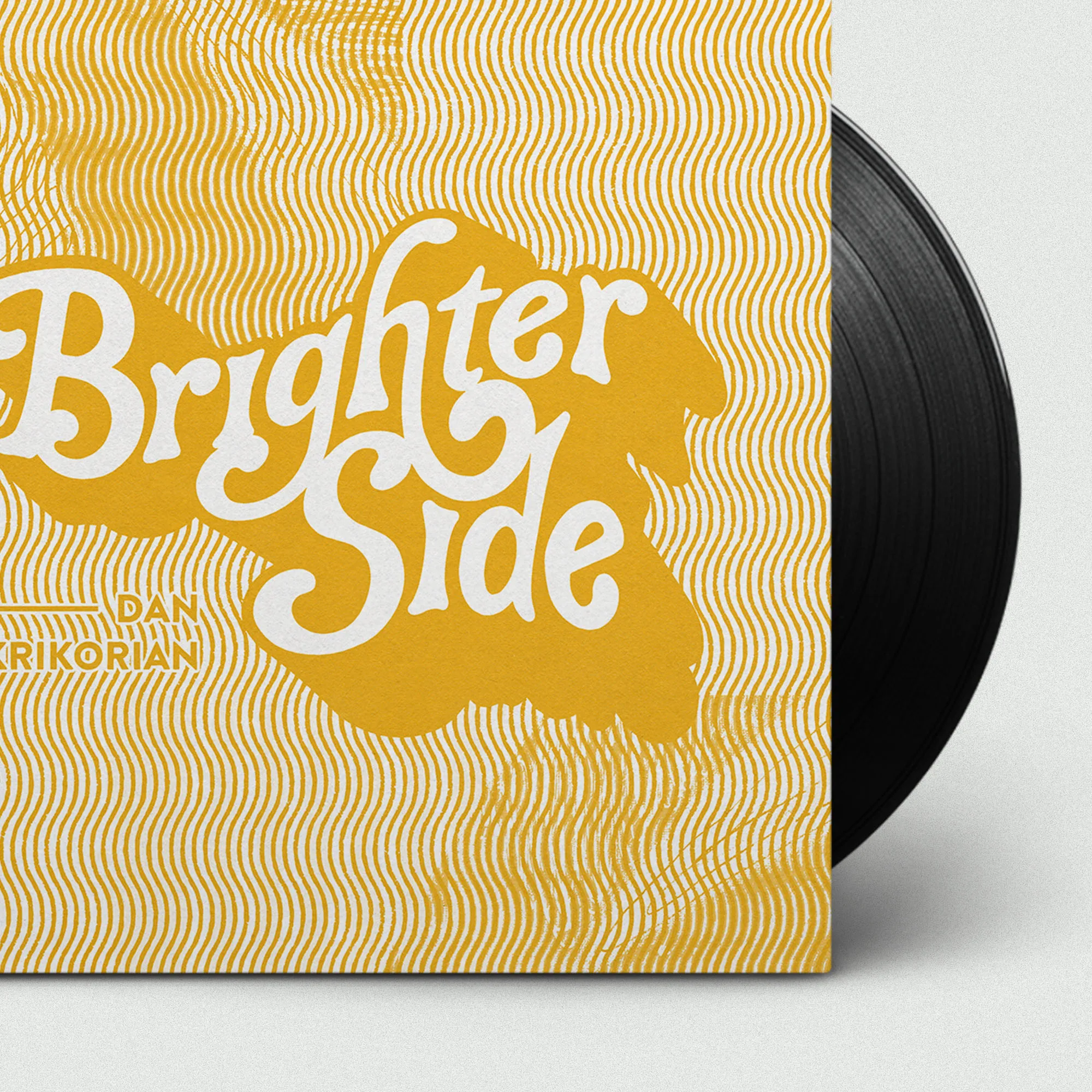 Dan Krikorian "Brighter Side" album cover in yellow retro script beside a vinyl record.